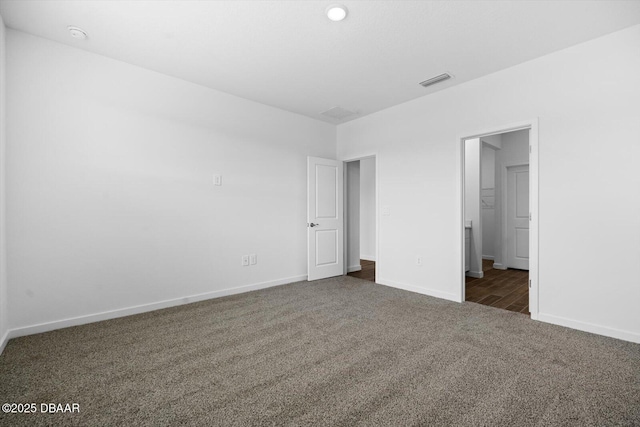 unfurnished bedroom with dark carpet