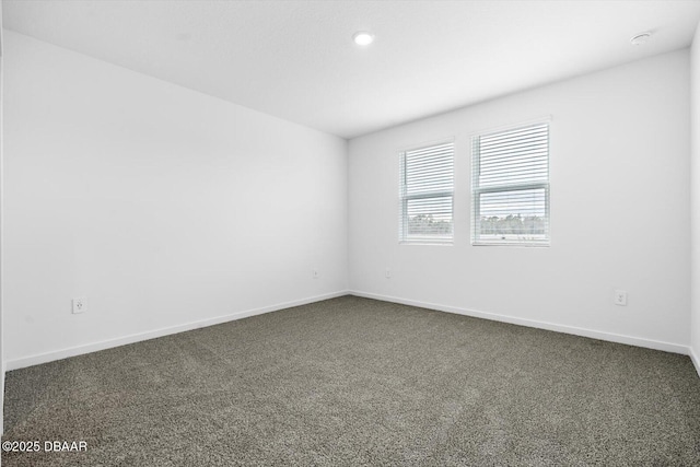 empty room featuring dark carpet