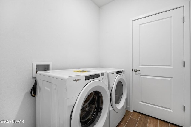 clothes washing area featuring washer and clothes dryer