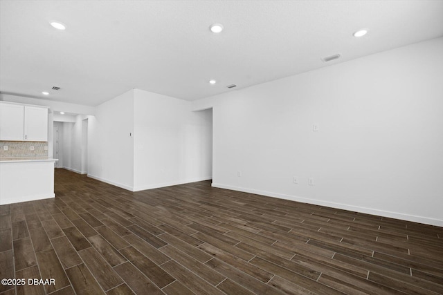 unfurnished living room featuring dark hardwood / wood-style floors