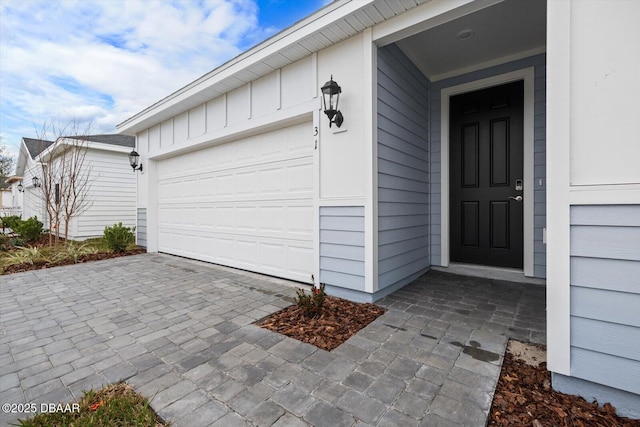 view of exterior entry featuring a garage