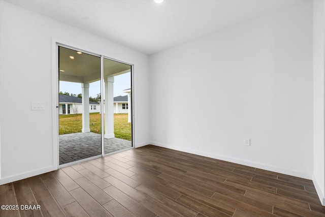 spare room featuring dark hardwood / wood-style flooring