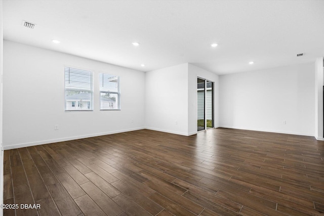 spare room featuring dark hardwood / wood-style floors