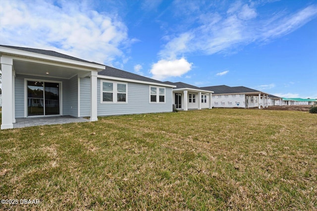 rear view of house with a patio area and a yard