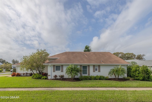682 Middlebury Loop, New Smyrna Beach, FL 32168 - single story home with stucco siding, a front yard, and a shingled roof