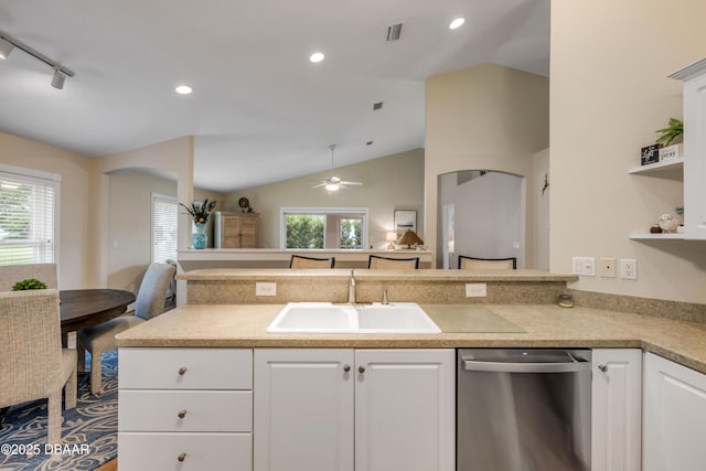 682 Middlebury Loop, New Smyrna Beach, FL 32168 - kitchen featuring dishwasher, vaulted ceiling, open floor plan, white cabinetry, and light countertops