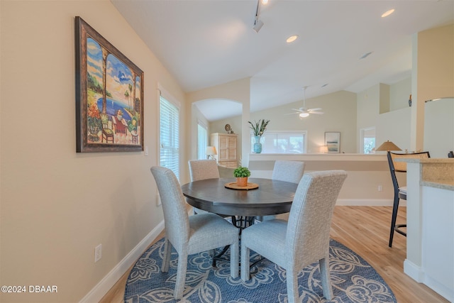 dining room with light hardwood / wood-style flooring, lofted ceiling, ceiling fan, and plenty of natural light