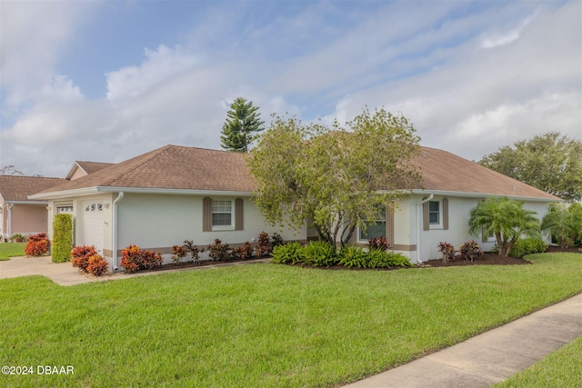 single story home featuring a front lawn and a garage