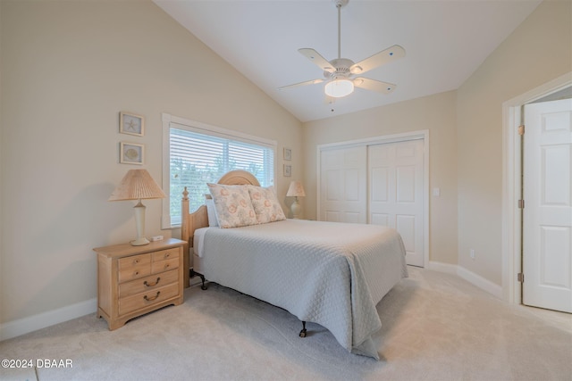 bedroom with ceiling fan, light carpet, a closet, and high vaulted ceiling