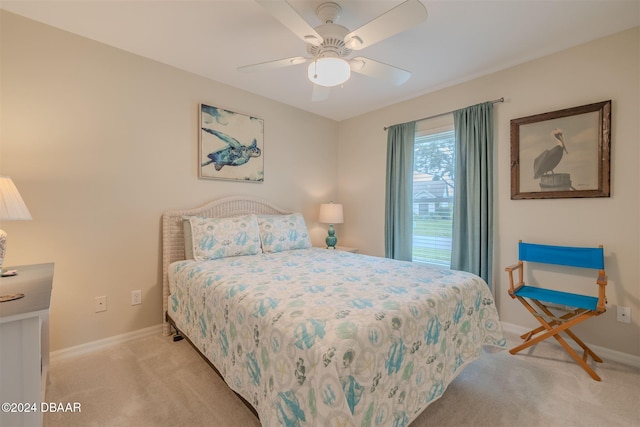 bedroom with ceiling fan and light carpet