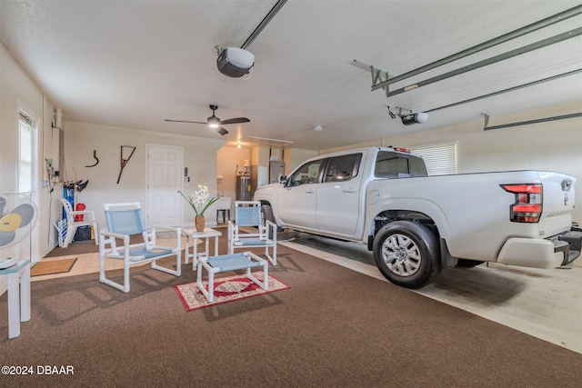 garage with a garage door opener and ceiling fan