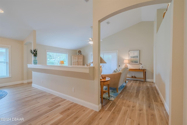 682 Middlebury Loop, New Smyrna Beach, FL 32168 - corridor with lofted ceiling, light wood-style floors, arched walkways, and baseboards