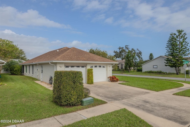 view of side of property with a garage and a yard