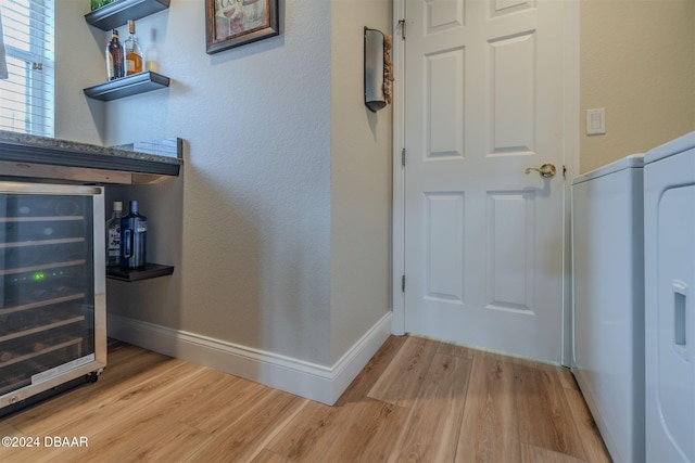 interior space featuring beverage cooler and light hardwood / wood-style floors