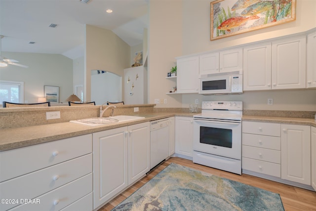 kitchen with light hardwood / wood-style floors, white cabinetry, sink, white appliances, and lofted ceiling