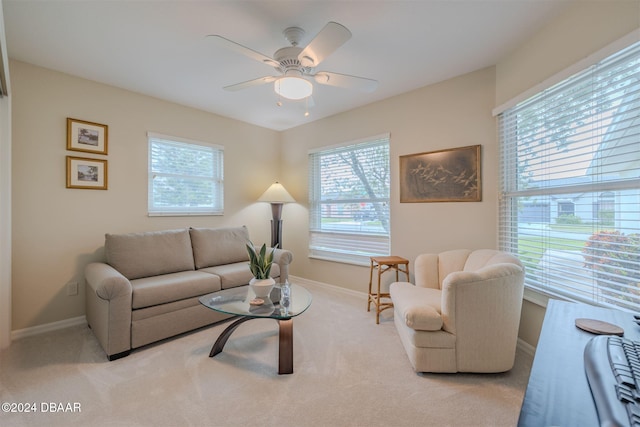 carpeted living room featuring ceiling fan