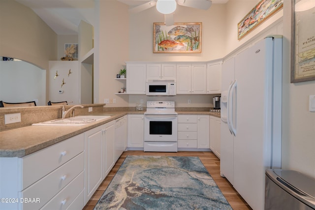 kitchen featuring white cabinets, white appliances, sink, and light hardwood / wood-style flooring