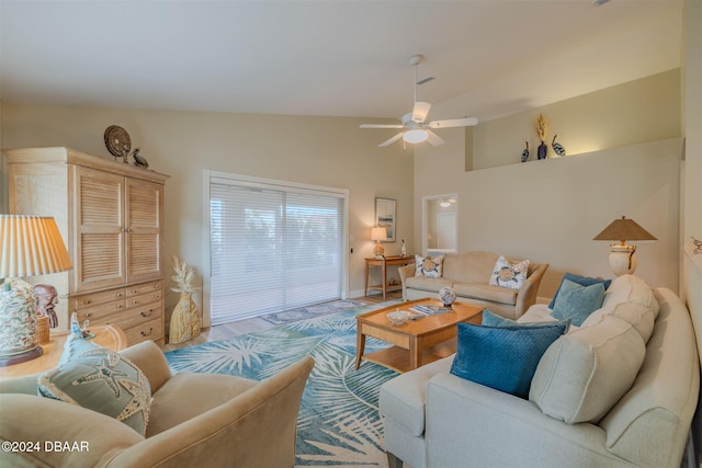 living room featuring ceiling fan, light hardwood / wood-style flooring, and vaulted ceiling