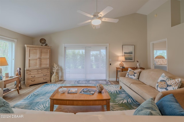 living room with ceiling fan, light hardwood / wood-style flooring, and vaulted ceiling