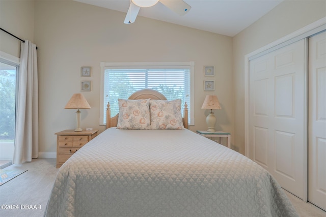 bedroom with light colored carpet, multiple windows, lofted ceiling, and ceiling fan