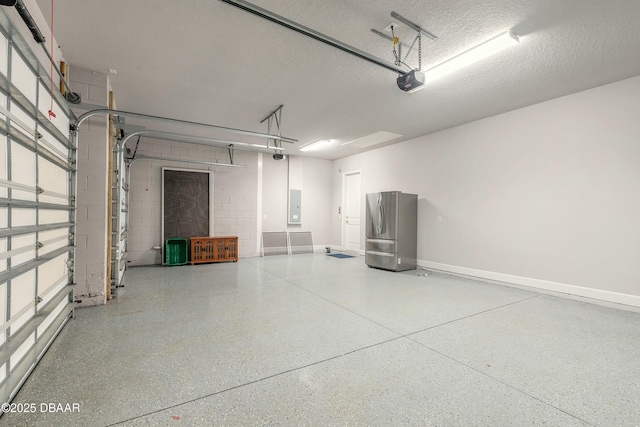 garage featuring a garage door opener, stainless steel fridge, and electric panel