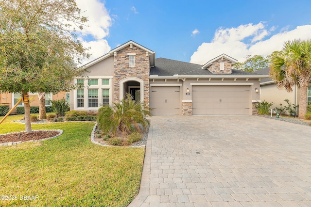 view of front of home with a garage and a front lawn