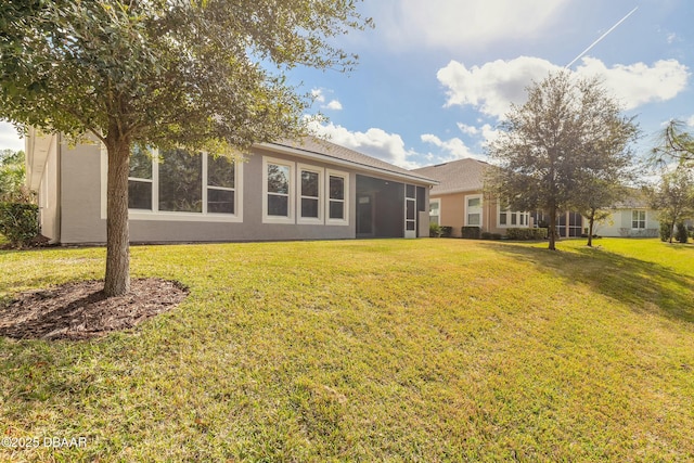 back of house with a lawn