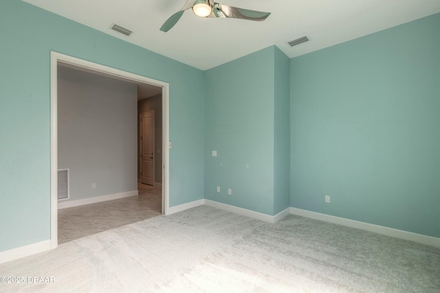 carpeted empty room featuring ceiling fan