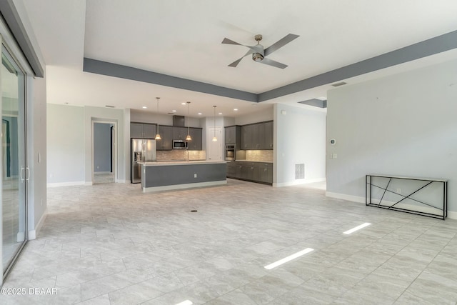 unfurnished living room featuring ceiling fan