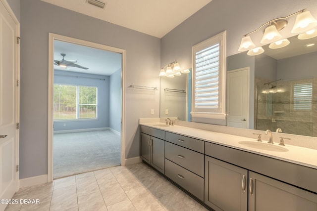 bathroom with ceiling fan, vanity, and a tile shower