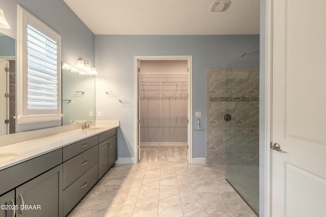 bathroom featuring vanity and tiled shower