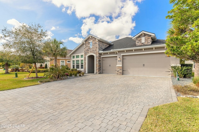 view of front of home with a garage and a front lawn