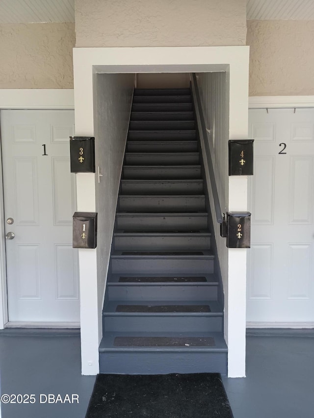 635 Tanglewood St, Daytona Beach, FL 32114 - stairway featuring finished concrete flooring and a textured wall