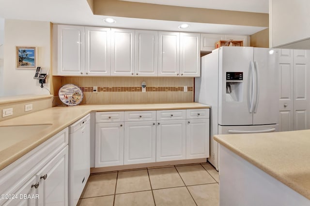 kitchen featuring white cabinets, white appliances, and light tile patterned floors