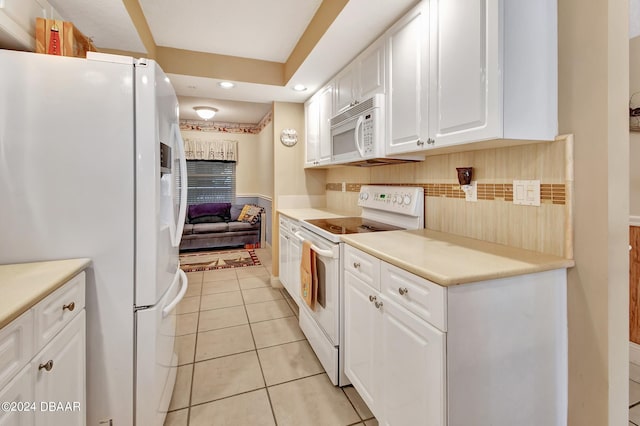 kitchen with white cabinets, light tile patterned floors, white appliances, and backsplash