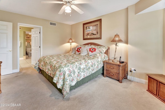 carpeted bedroom with ceiling fan and ensuite bath