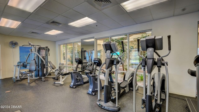 exercise room featuring a drop ceiling