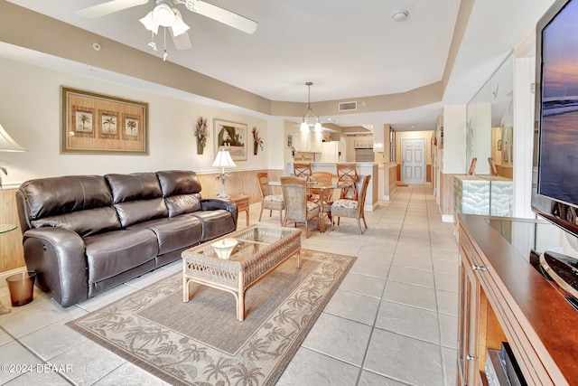 living room with ceiling fan and light tile patterned flooring