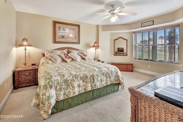 bedroom with ceiling fan and light carpet