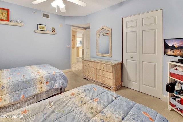 carpeted bedroom featuring ceiling fan and a closet