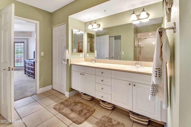 bathroom featuring walk in shower, vanity, and tile patterned floors