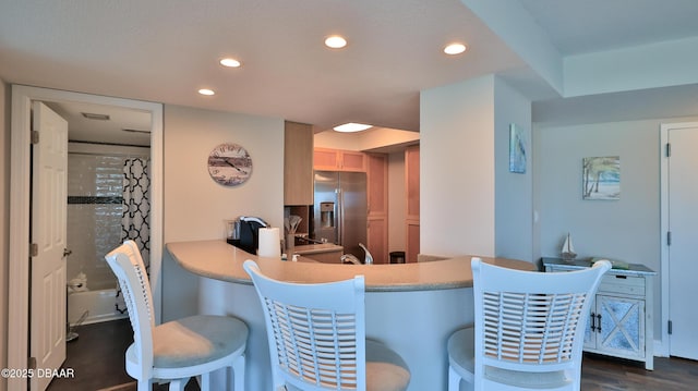 2625 S Atlantic Ave Unit 5Sw, Daytona Beach, FL 32118 - kitchen featuring stainless steel refrigerator with ice dispenser, recessed lighting, a breakfast bar area, and light countertops