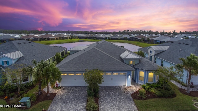 aerial view at dusk with a water view