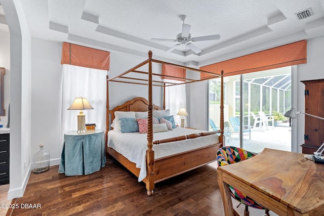 1214 Hampstead Ln, Ormond Beach, FL 32174 - bedroom with a tray ceiling, access to outside, dark wood-style flooring, and a ceiling fan