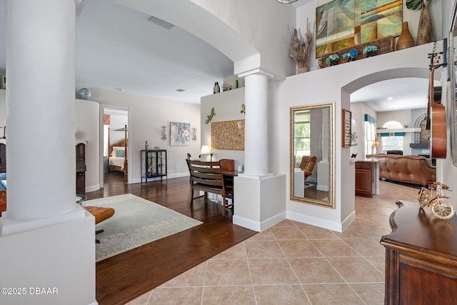 1214 Hampstead Ln, Ormond Beach, FL 32174 - foyer with arched walkways, ornate columns, and light tile patterned floors