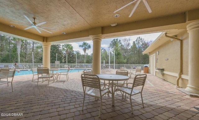 view of patio featuring a community pool and ceiling fan