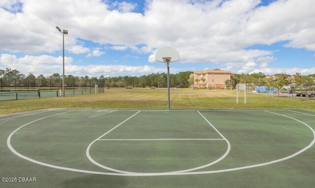 view of basketball court featuring a lawn