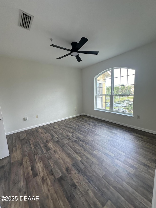 unfurnished room featuring dark hardwood / wood-style flooring and ceiling fan