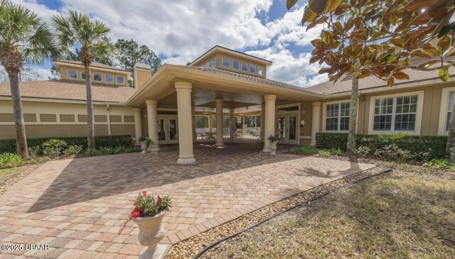 rear view of house featuring french doors