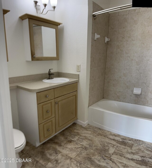 full bathroom with tiled shower / bath combo, vanity, and toilet